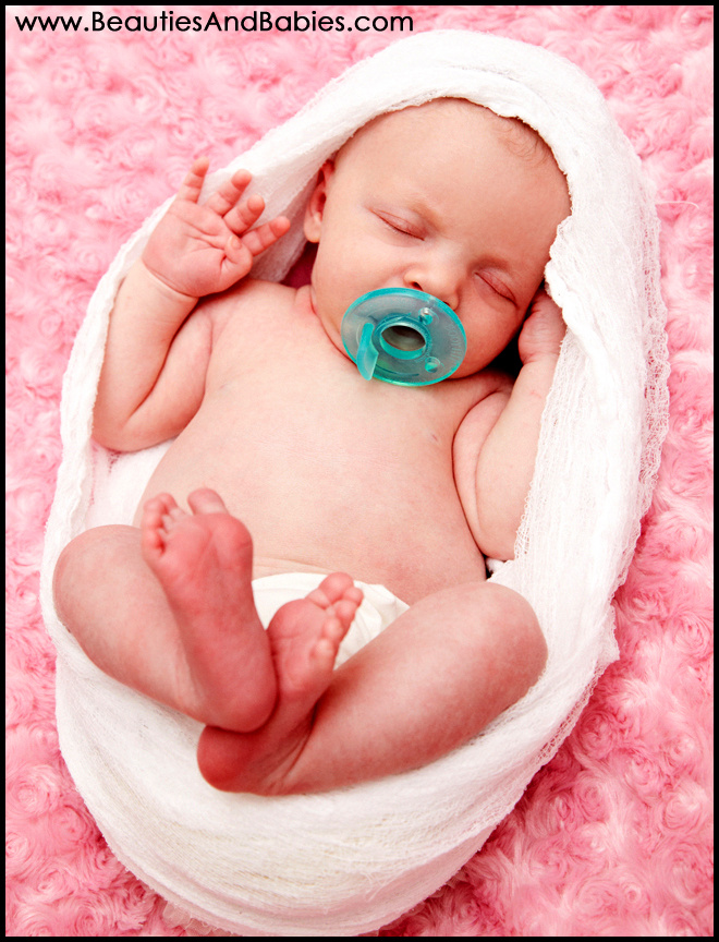 newborn baby girl sleeping nude professional photographer